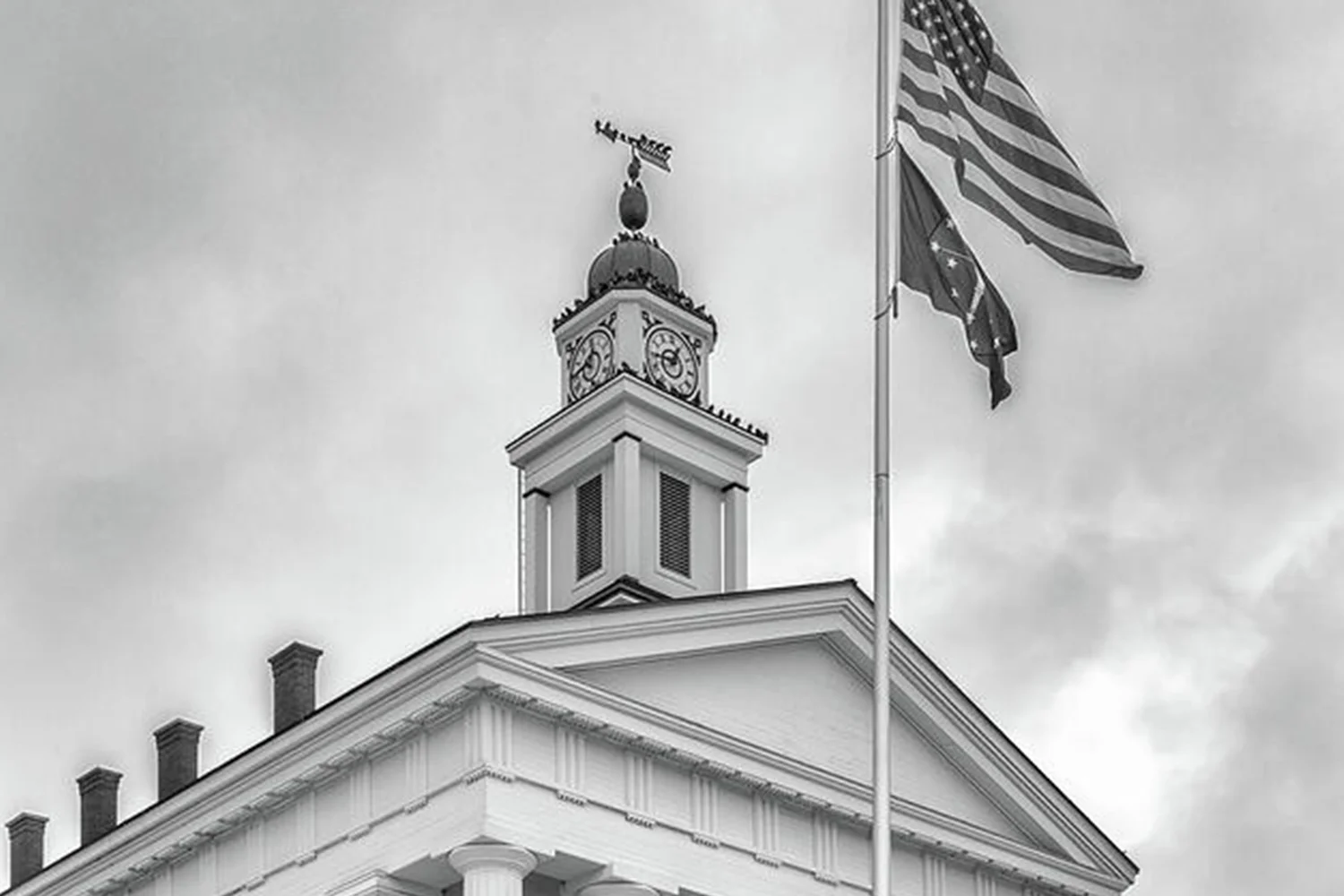 Historic Orange County Texas courthouse with clock tower and American flag, representing local property tax protest services.