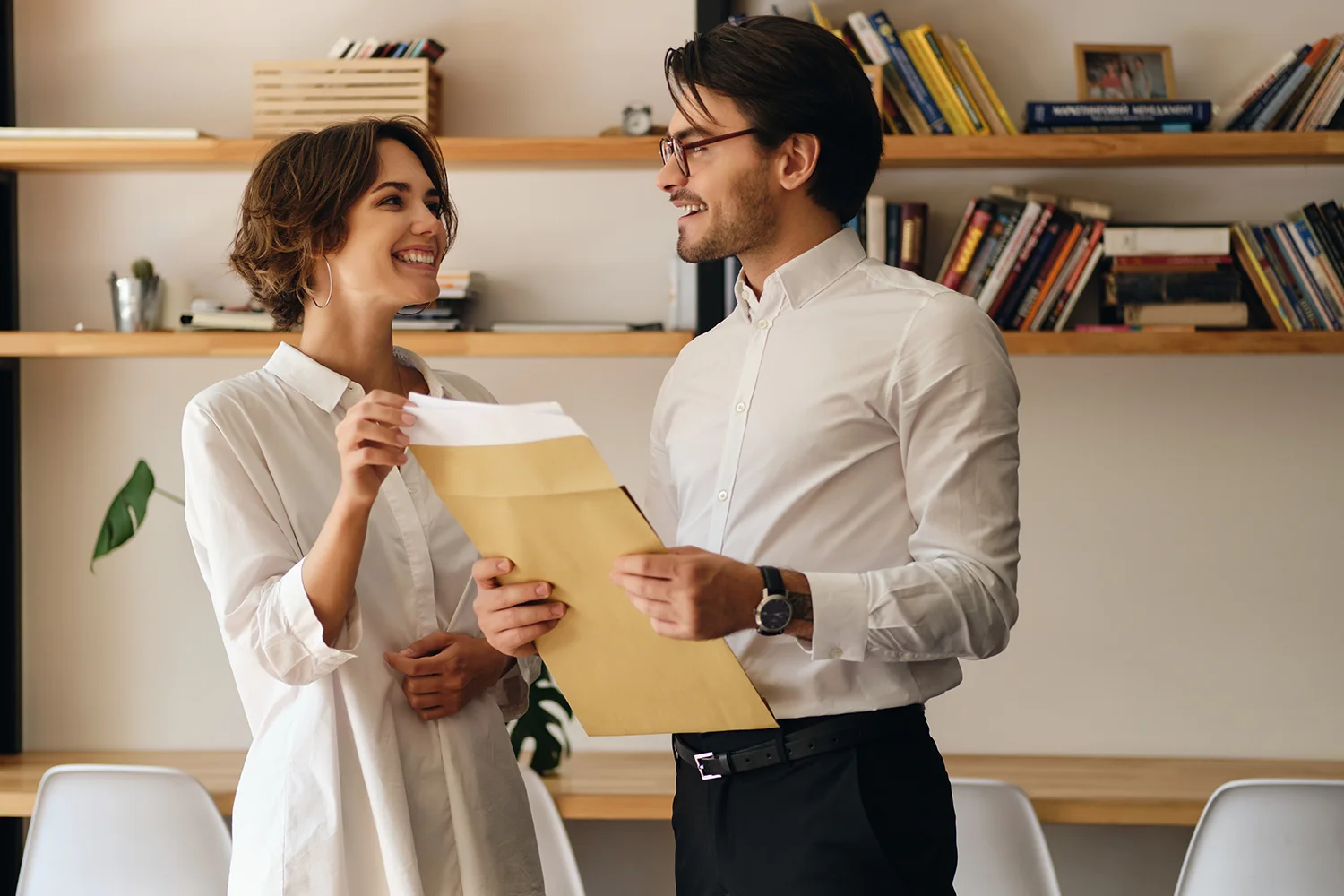 Smiling couple holding property tax protest documents, representing the satisfaction of homeowners benefiting from Tax Cutter's expert services in Houston, Texas.