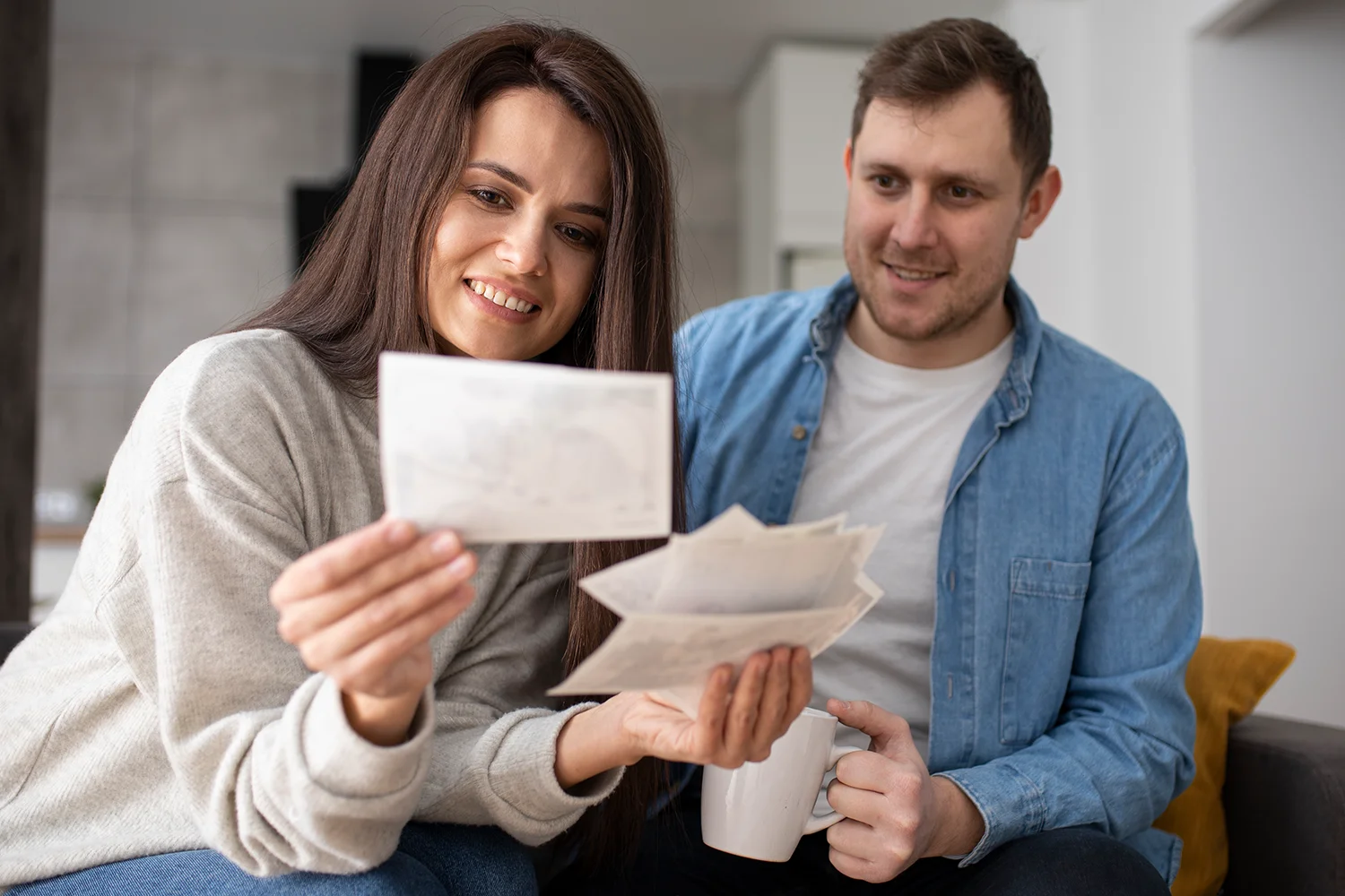 Happy Houston homeowners reviewing documents and celebrating property tax savings after successful tax protest with Tax Cutter. 