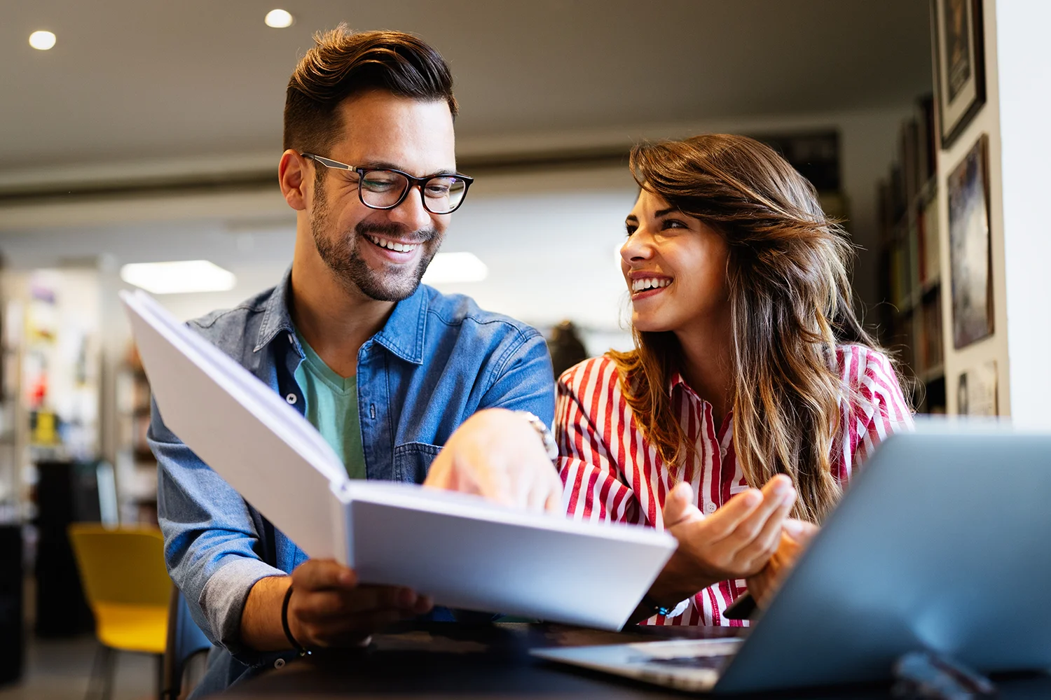 Couple happily reviewing property tax documents, reflecting their satisfaction with Tax Cutter’s services for property tax appeals in Houston, Texas. 