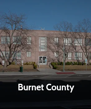 Burnet County courthouse building in Texas with brick facade and leafless trees, representing Houston property tax protest services by Tax Cutter.