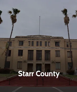 Starr County Courthouse building with palm trees and grand staircase in Texas, showcasing local property tax appeal support by Tax Cutter.