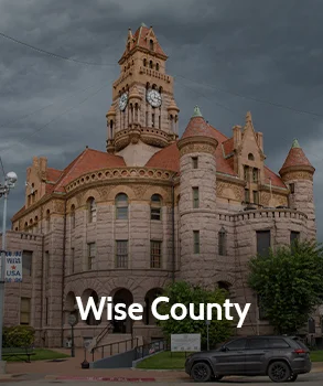 Wise County Courthouse in Texas with historic stone architecture and clock tower under cloudy sky, symbolizing property tax appeal services.